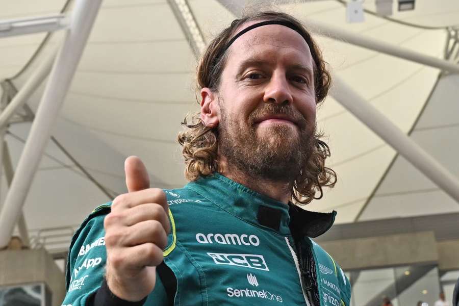 Aston Martin's German driver Sebastian Vettel gives the thumbs-up as he arrives for an end-of-season drivers group picture