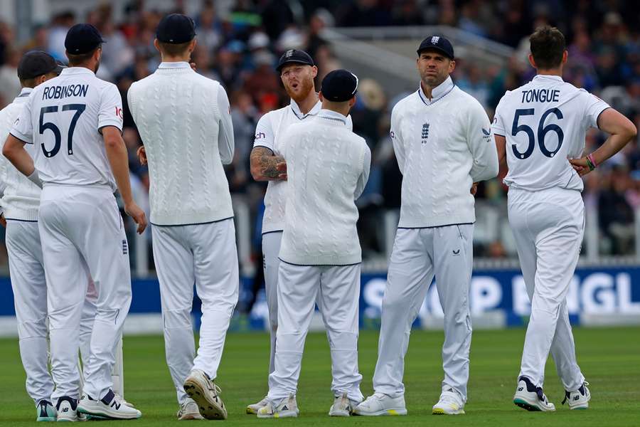 England captain Ben Stokes (C) and James Anderson (2R) react after a review overturns a decision