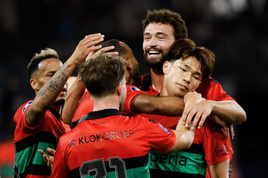 NEC's Kento Shiogai (R) gets swarmed by teammates after scoring the 3-1 against Heracles Almelo