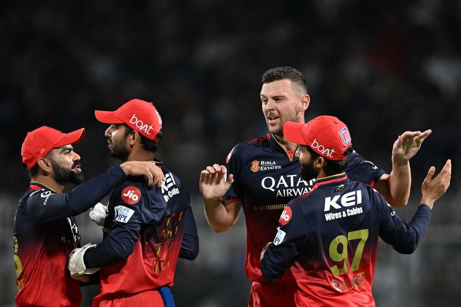 Royal Challengers Bengaluru's Josh Hazlewood (2R) celebrates after taking the wicket of Kolkata Knight Riders' Quinton de Kock