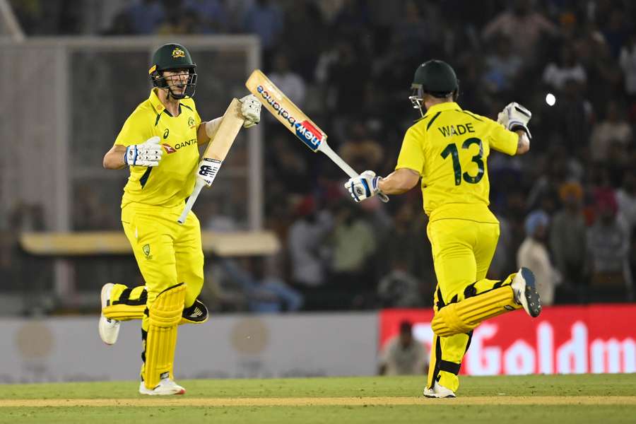 Australia's Matthew Wade (R) celebrates with teammate Pat Cummins after winning the first T20 international against India.