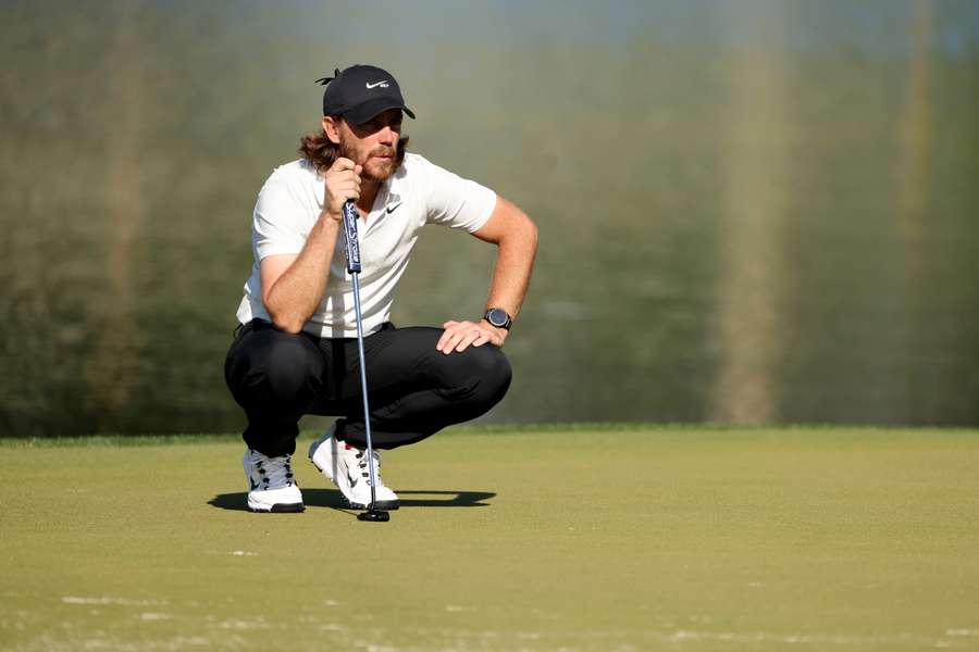 Tommy Fleetwood of England lines up a putt