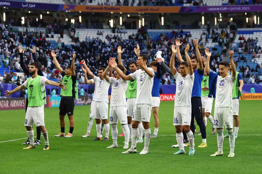 Uzbekistan players celebrate after the match