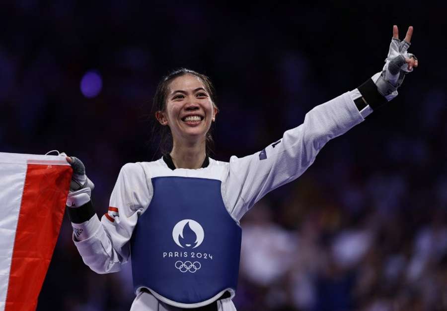 Panipak Wongpattanakit of Thailand celebrates winning the gold medal against Guo Qing of China