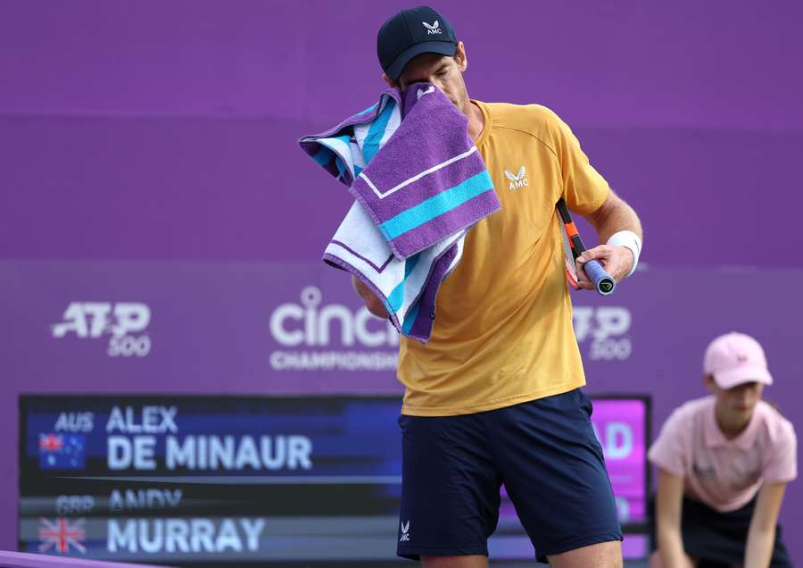 Andy Murray uses a towel as he plays against Australia's Alex de Minaur