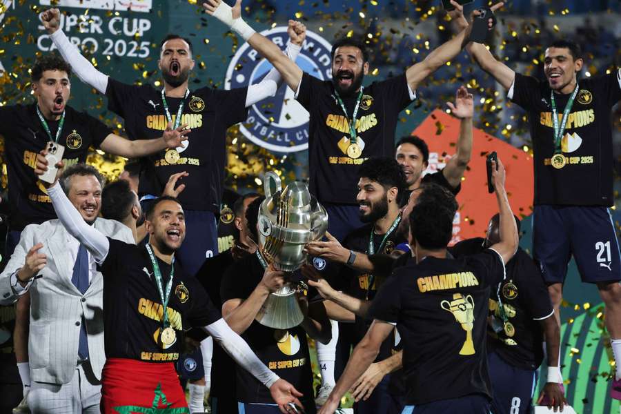 Pyramids' Ali Gabr lifts the trophy as he celebrates winning the African Super Cup with teammates