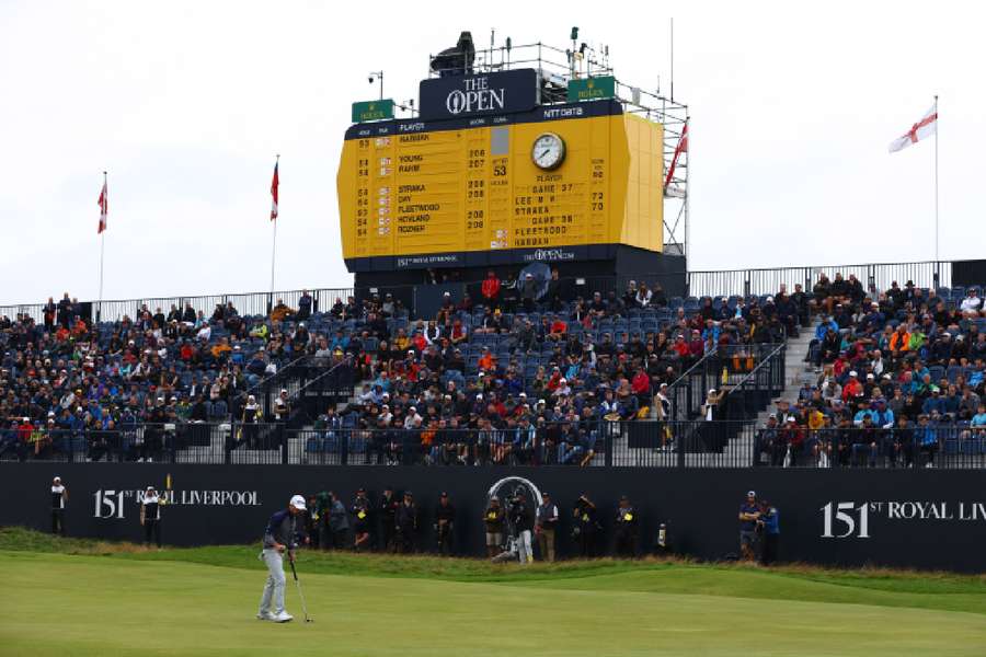 Brian Harman celebrates making par on the 18th green during the third round