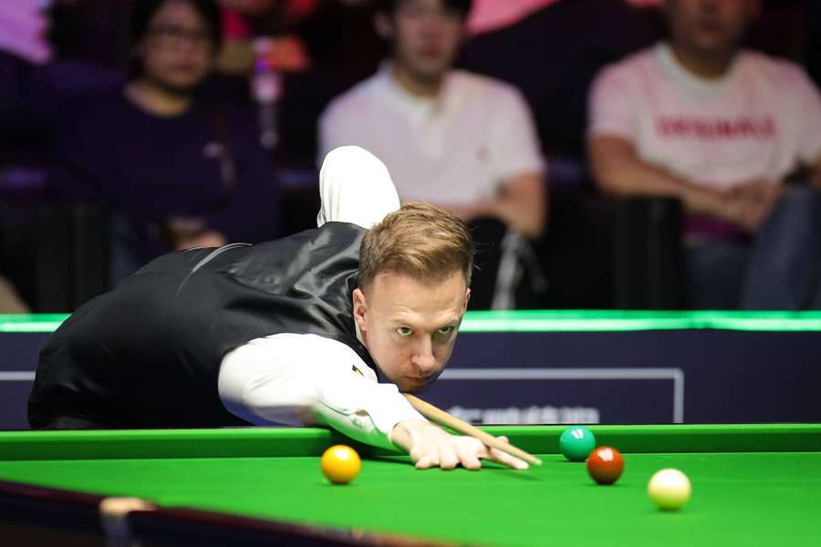 Judd Trump of England plays a shot in the final match against Ding Junhui of China