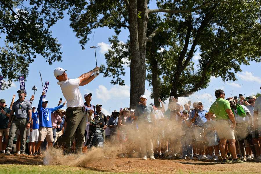 Rory McIlroy hits his shot from the rough