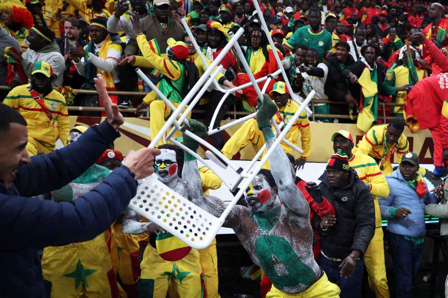 A Senegal fan clashes with security during the AFCON final