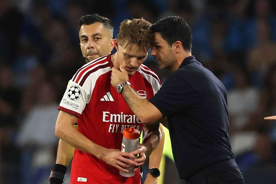 Arteta (L) speaks with Odegaard Arteta (L) speaks with Odegaard