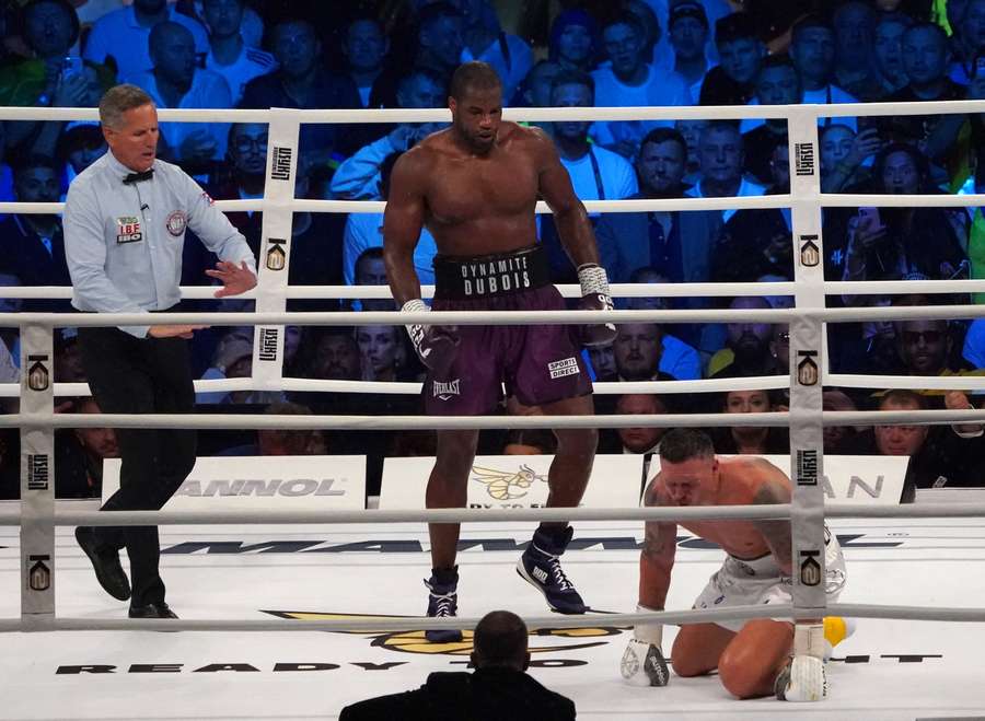 Ukraine’s reigning world heavyweight champion Oleksandr Usyk (R) is on the ground during his fight against challenger Daniel Dubois