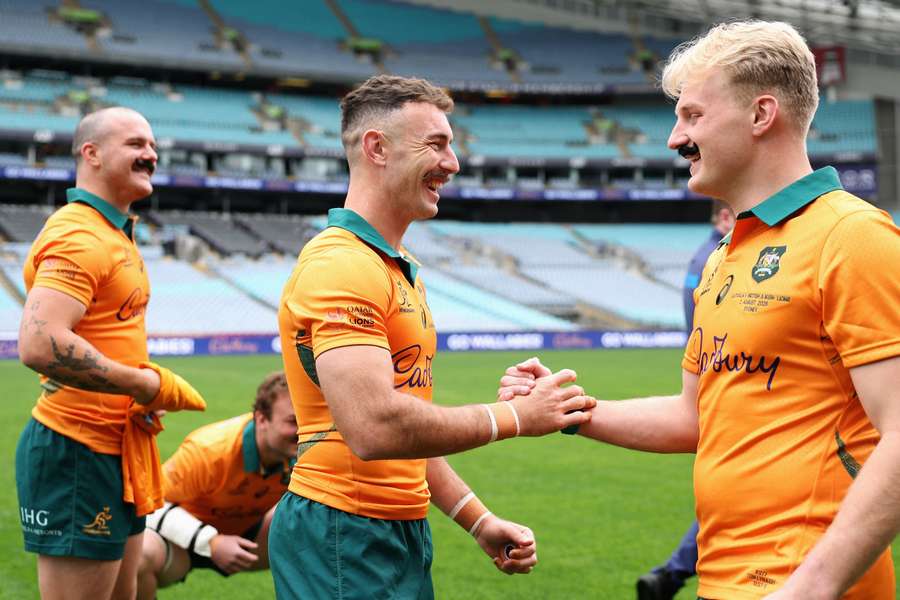 Impending retiree Nic White is embraced by captain Tom Lynagh and teammates at the captain's run. 