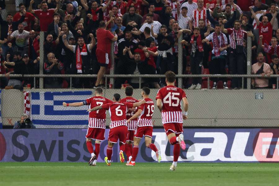 Olympiacos players celebrate after scoring against Fenerbahce