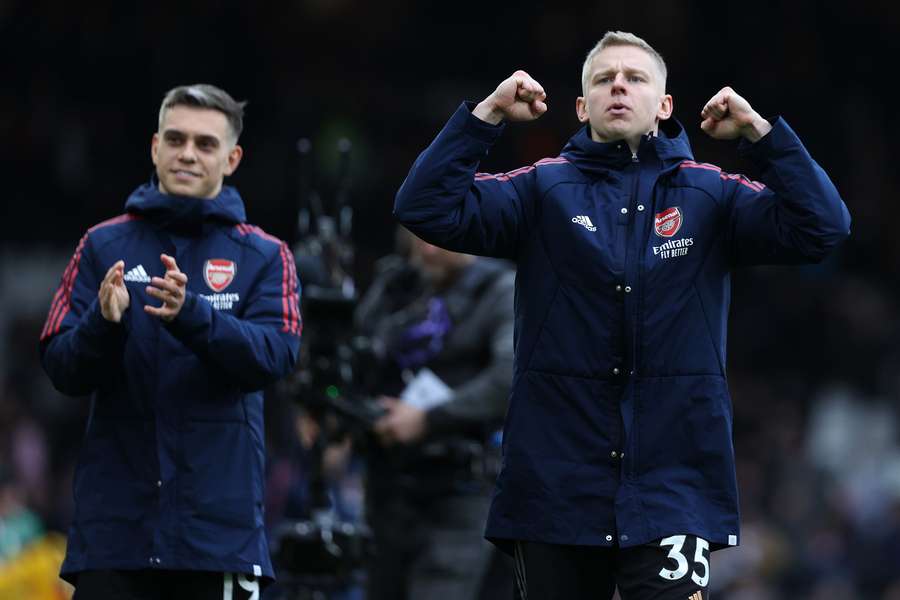 Oleksandr Zinchenko (R) and Leandro Trossard celebrate after Arsenal's 3-0 win against Fulham