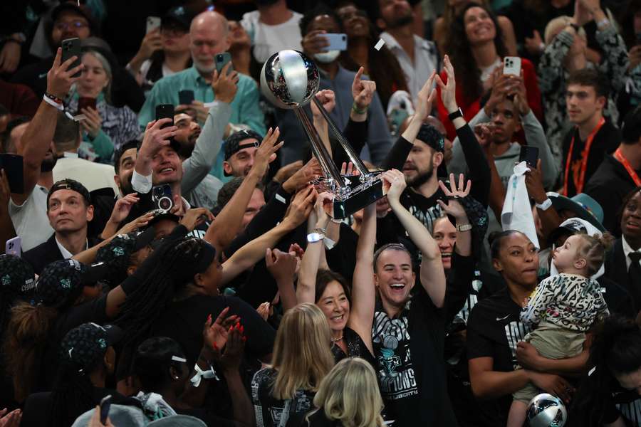 New York Liberty players hoist the Championship Trophy after defeating the Minnesota Lynx to win Game Five of the WNBA Finals