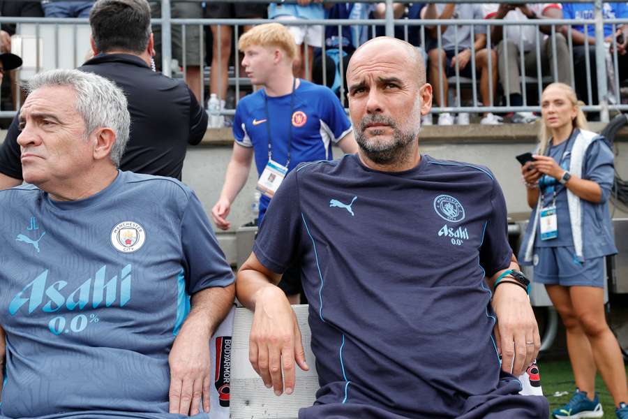 Guardiola, seated next to his assistant Juanma Lillo