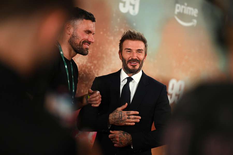 Former Manchester United footballer David Beckham reacts on the red carpet upon arrival to attend the world premiere of the documentary '99'