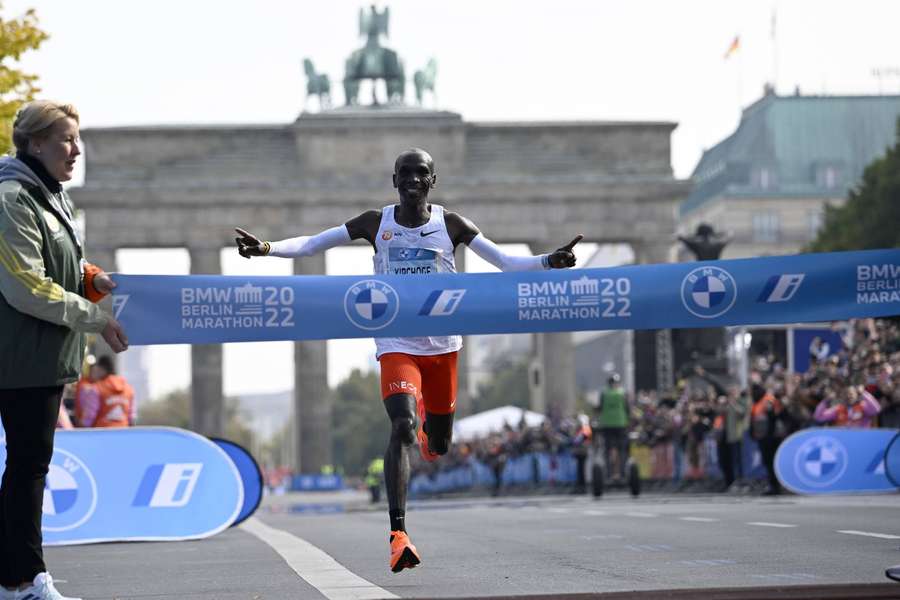 Kenya's Eliud Kipchoge crosses the finish line to win the Berlin Marathon in a record-breaking time.