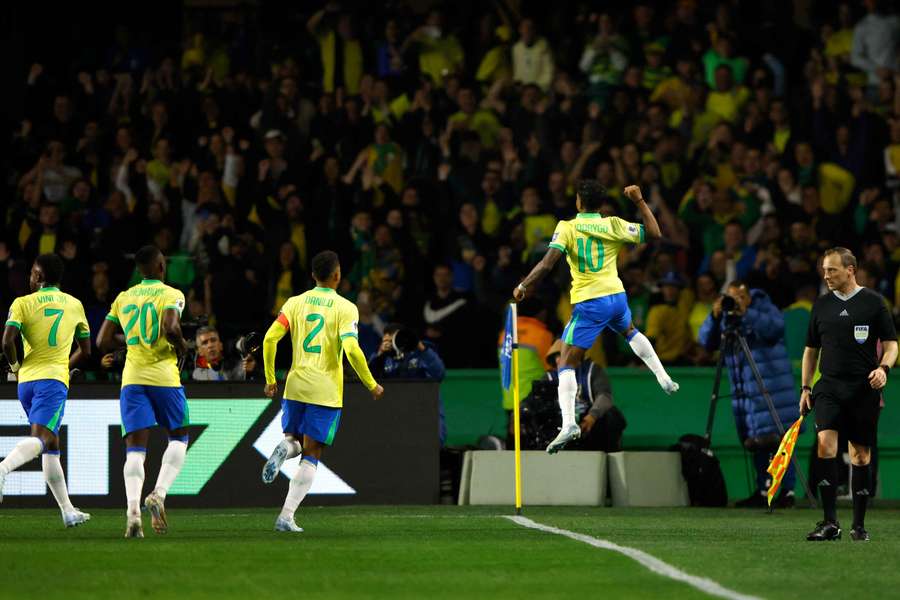 Rodrygo (right) celebrates scoring Brazil's goal