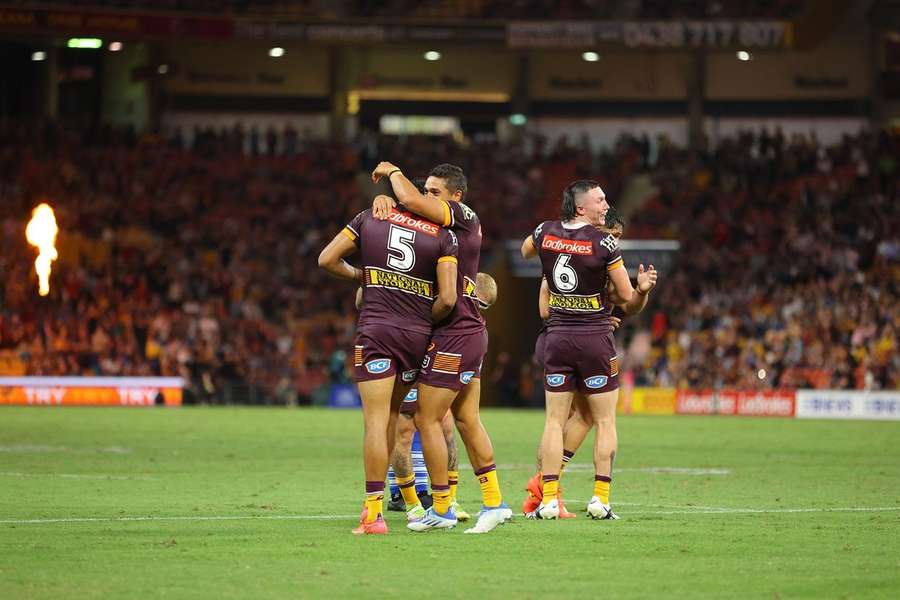 The Brisbane Broncos (players pictured) are currently top of the NRL