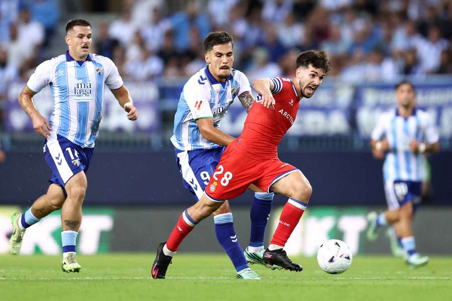 Javi Hernandez of Espanyol is challenged by Chupe of Malaga