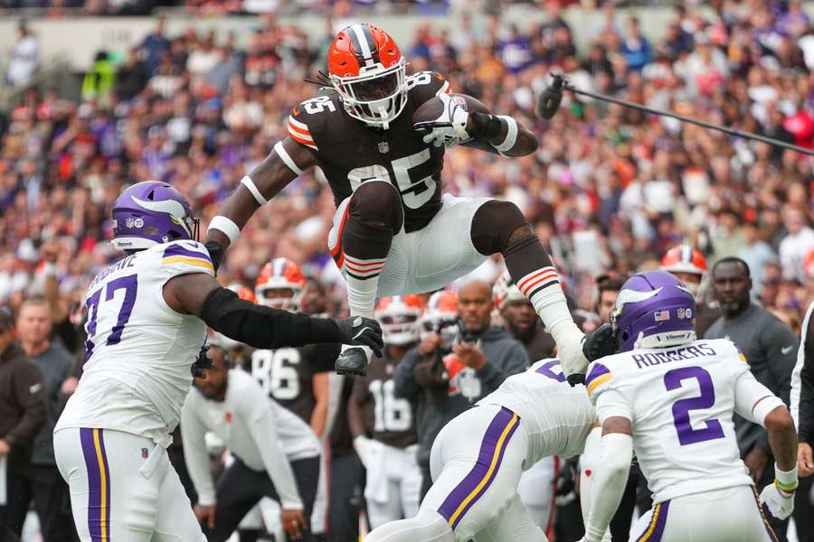 Cleveland Browns tight end David Njoku (85) leaps into the air to avoid the Vikings' defence