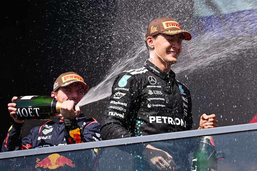 Max Verstappen sprays champagne on winner George Russell at the Canadian Grand Prix
