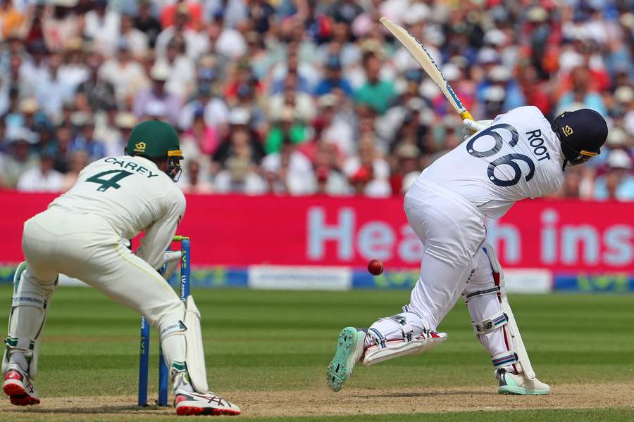 Australia's wicket keeper Alex Carey (L) prepares to stump England's Joe Root to dismiss him for 46 runs