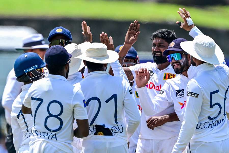 Sri Lanka's Prabath Jayasuriya celebrates with teammates after the dismissal of New Zealand's Tom Blundell