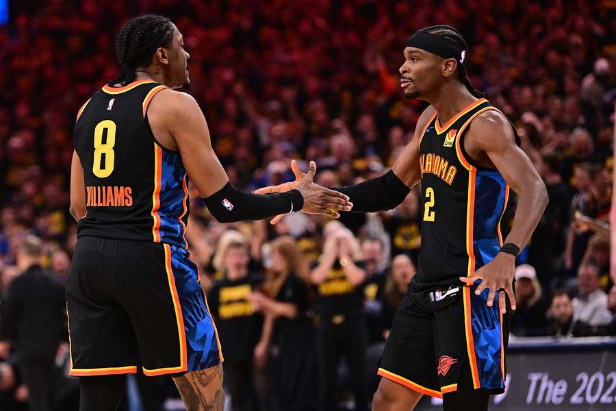 Jalen Williams (left) and Shai Gilgeous-Alexander of the Oklahoma City Thunder celebrate during the first half against the Nuggets