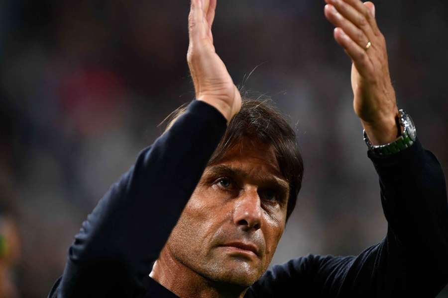 Antonio Conte applauds supporters after the match