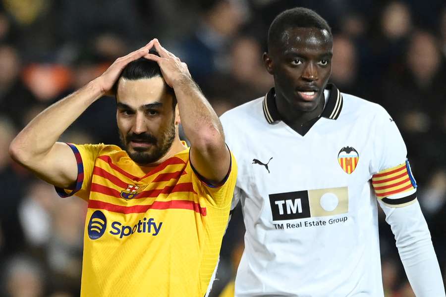 Barcelona's German midfielder #22 Ilkay Gundogan reacts next to Valencia's Guinean defender #04 Mouctar Diakhaby