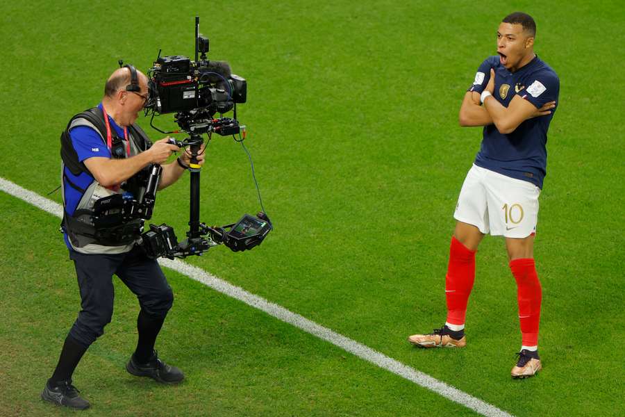 Kylian Mbappe celebrates scoring his team's third goal against Poland