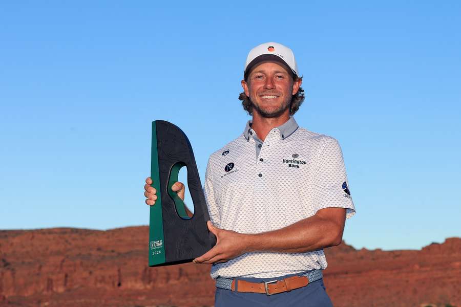 Austin Smotherman poses with the winner's trophy after winning the Bank of Utah Championship