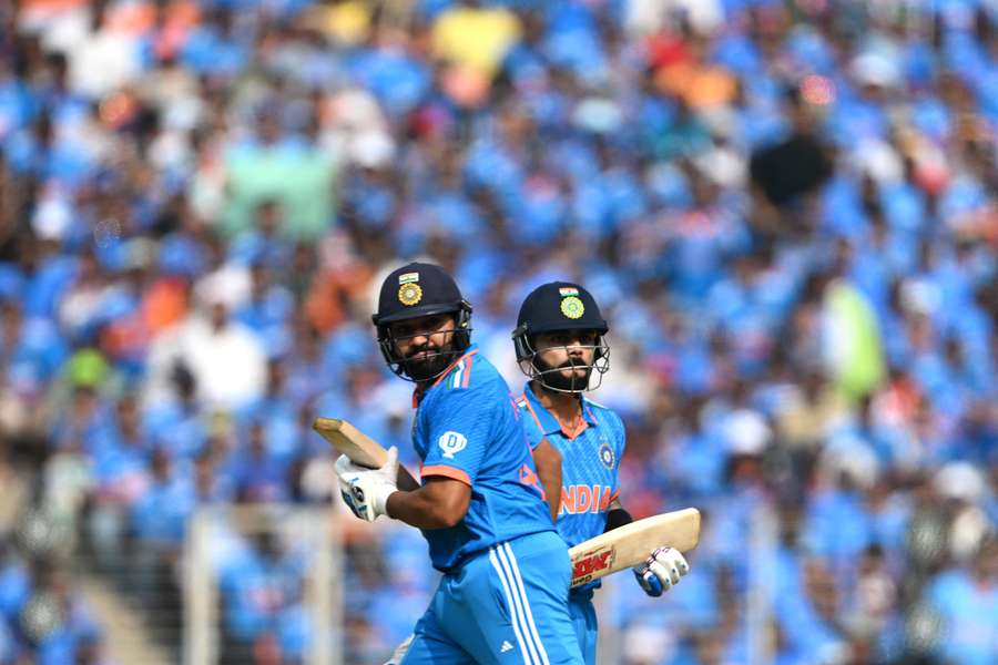 India captain Rohit Sharma (L) and his teammate Virat Kohli run between the wickets