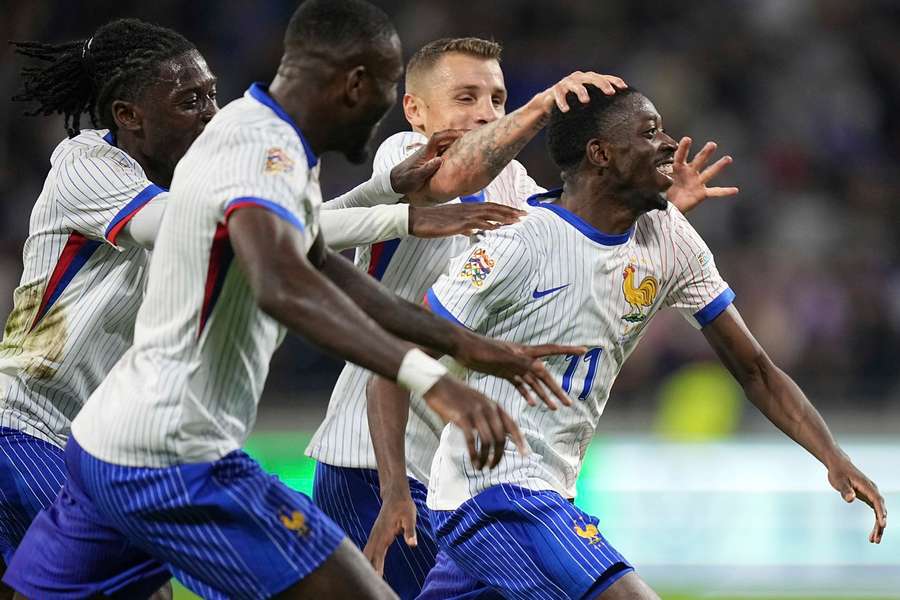 France's Ousmane Dembele (right) celebrates with teammates after scoring his side's second goal against Belgium 