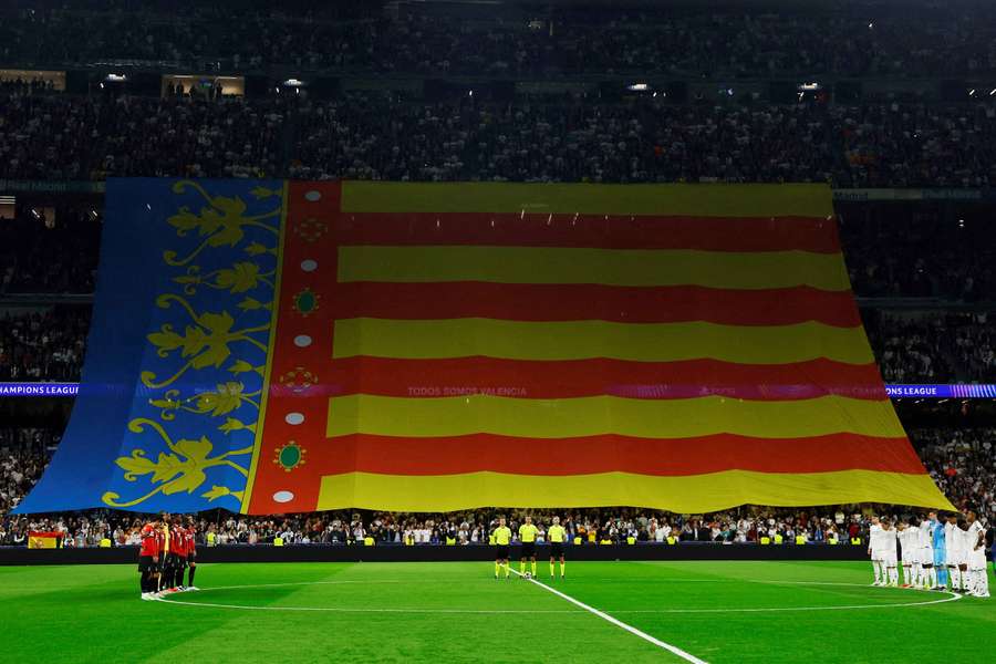 View of the flag of Valencia in the stands as players observe a minute's silence ahead of Real Madrid's match with AC Milan