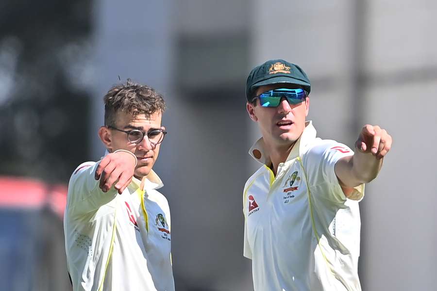 Australia's Todd Murphy with captain Pat Cummins (R) 