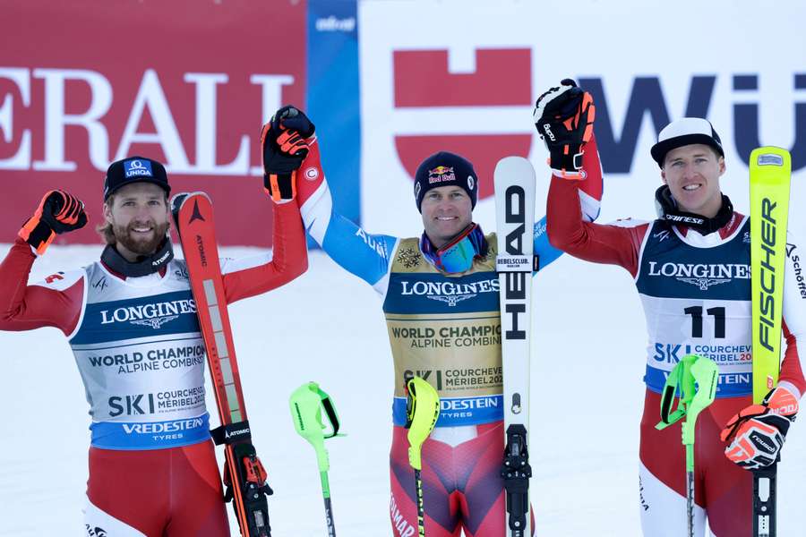 Alexis Pinturault celebrates winning the Men's Alpine Combined alongside Austria's Marco Schwarz and Raphael Haaser