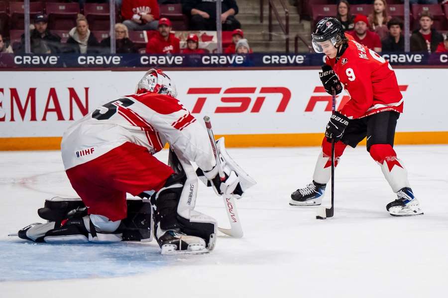 Canada's Gavin McKenna scores on Denmark goaltender Patrick Tiedjen to complete his hat trick at the world junior hockey championship Canada's Gavin McKenna scores on Denmark goaltender Patrick Tiedjen to complete his hat trick at the world junior hockey championship