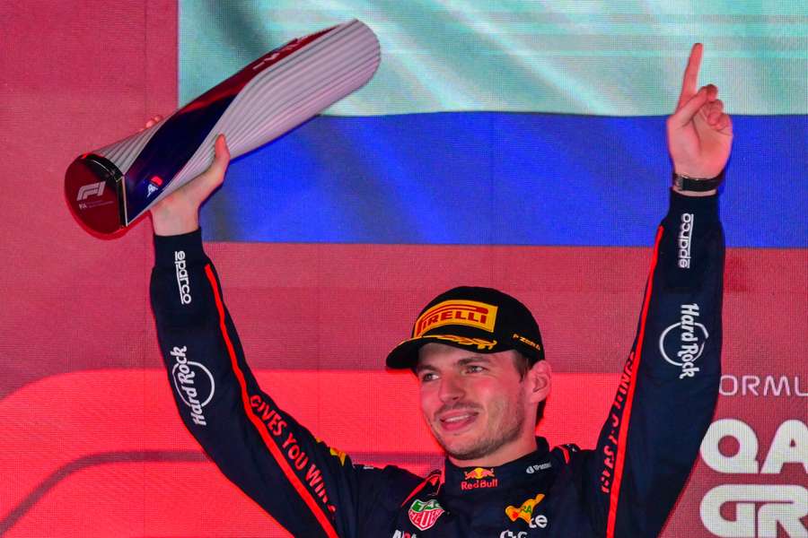 Red Bull Racing's Dutch driver Max Verstappen holds up the trophy on the podium in Qatar