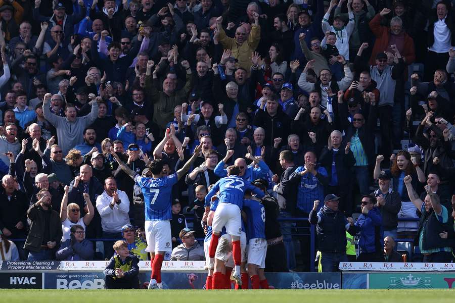 Colby Bishop celebrates with teammates after giving Portsmouth the lead