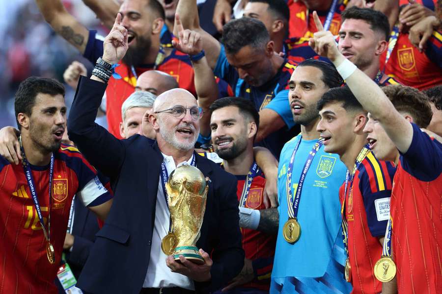 Spain coach Luis De La Fuente celebrates with the World Cup trophy alongside his players Spain coach Luis De La Fuente celebrates with the World Cup trophy alongside his players