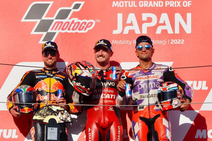 Jack Miller (C) celebrates winning the Japanese MotoGP alongside Brad Binder (L) and Jorge Martin (R)