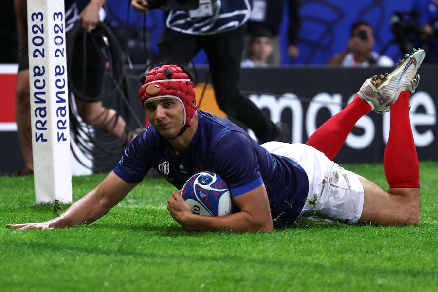 France's wing Louis Bielle-Biarrey scores a try during the France 2023 Rugby World Cup Pool A match between France and Uruguay