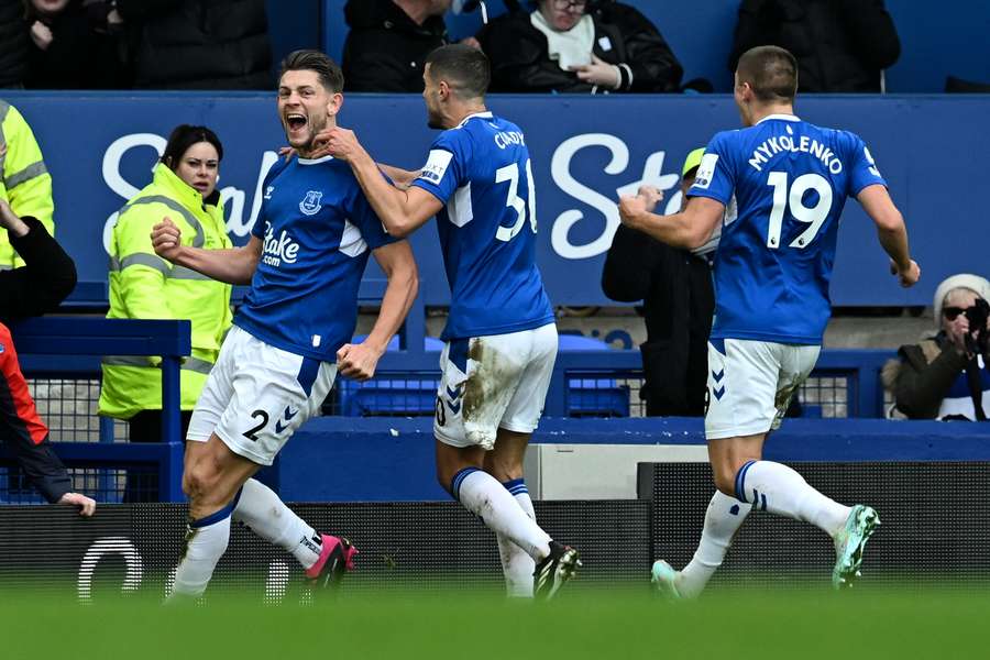 Everton's English defender James Tarkowski (L) celebrates with teammates