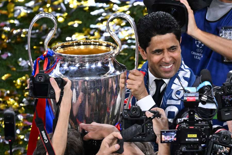 PSG president Nasser al-Khelaifi holds the Champions League trophy aloft