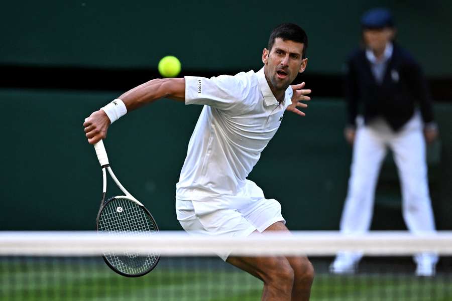 Novak Djokovic plays a drop shot against Jordan Thompson