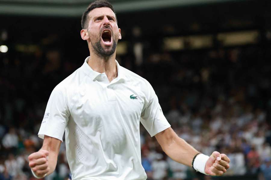 Novak Djokovic celebrates after winning a marathon quarter-final